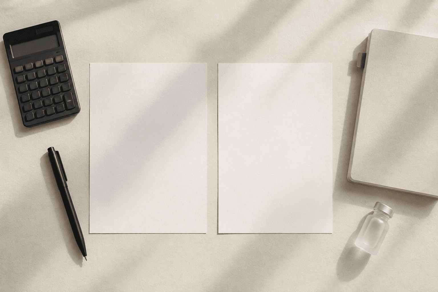 Two blank estimate sheets, a calculator and a travel notebook arranged side by side